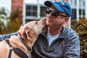 a dog licking its owner’s face 